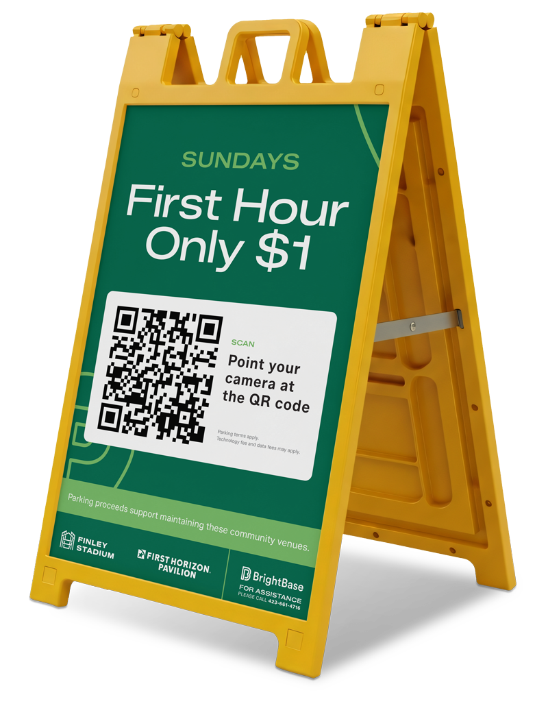 A yellow A-frame sign advertising a promotion for Sundays offering the first hour for only $1, with a QR code for scanning and pointing a camera at. The sign mentions parking proceeds support community venues and includes logos for Finley Stadium, First Horizon Pavilion, and BrightBase. Smaller text indicates parking terms and a phone number for assistance.