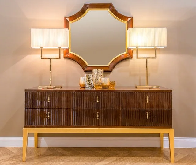Instant hotel glam for this buffet cabinet paired with an oddly shaped mirror