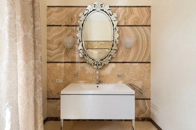 This vintage-looking oval mirror added elegance to the plain cabinet inside the powder room