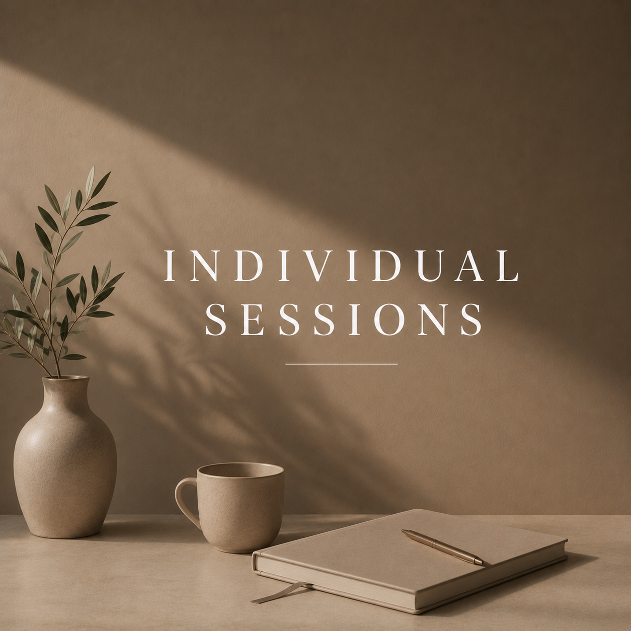 A beige vase with greenery, a beige cup, a closed beige notebook with a pen on top, and the words "Individual Sessions" on a beige wall with soft shadows.