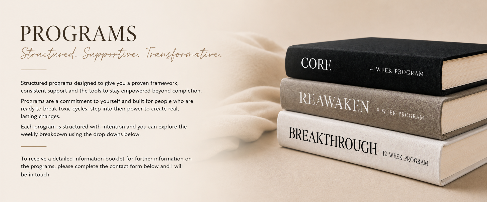 Stacked books labeled 'CORE 4 WEEK PROGRAM', 'REAWAKEN 8 WEEK PROGRAM', and 'BREAKTHROUGH 12 WEEK PROGRAM' on a beige surface with a beige fabric background.