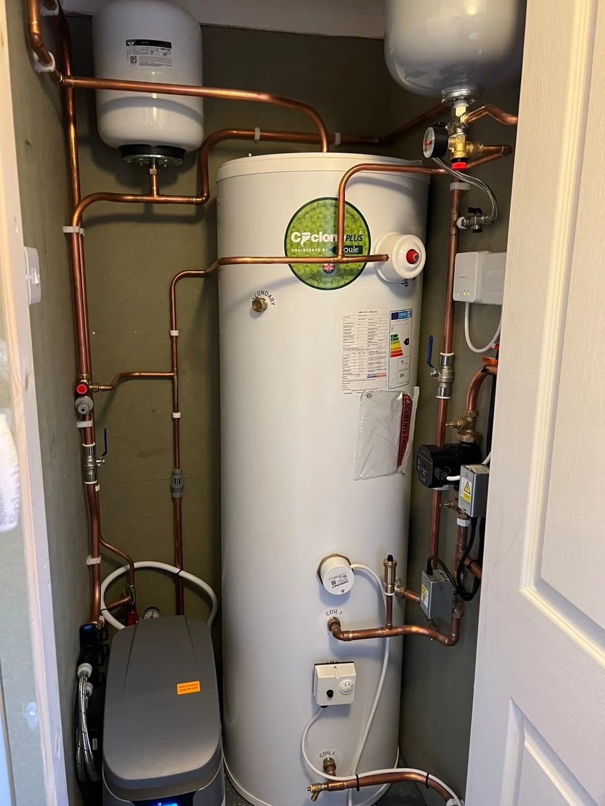 Compact hot water & Heating system replacement mounted in an airing cupboard"