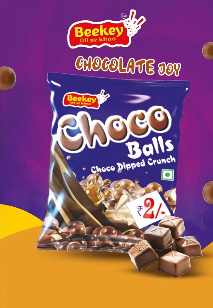 A purple snack bag labeled 'Beekey Chocolate Joy' featuring chocolate-covered balls called 'Choco Balls' with a description 'Choco Dipped Crunch,' showing an image of chocolate candies. There are also chocolates placed in front of the bag and a price