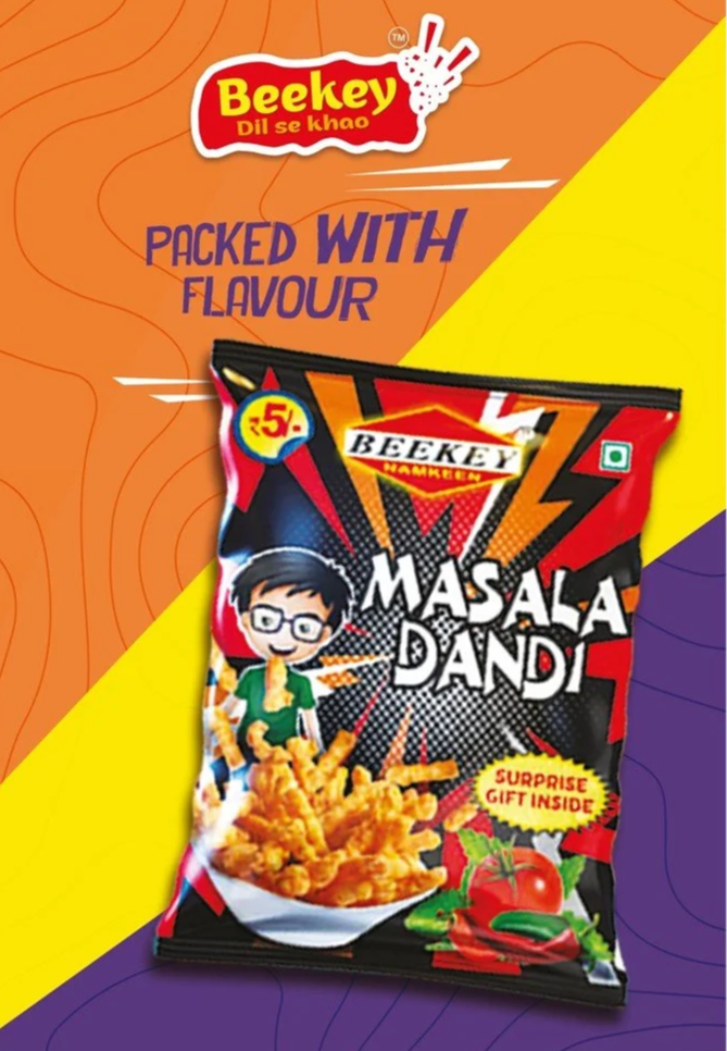 A packet of Beekey Masala Dandi snack flavor, with a cartoon boy, a bowl of the snack, and tomatoes and green chili peppers on the packaging.