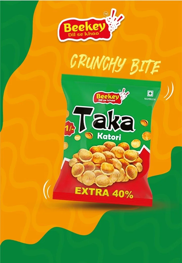 Packaging of Beekey Taka Katori crunchy snack with a green and red bag, showing an image of the snack and text indicating extra 40%.