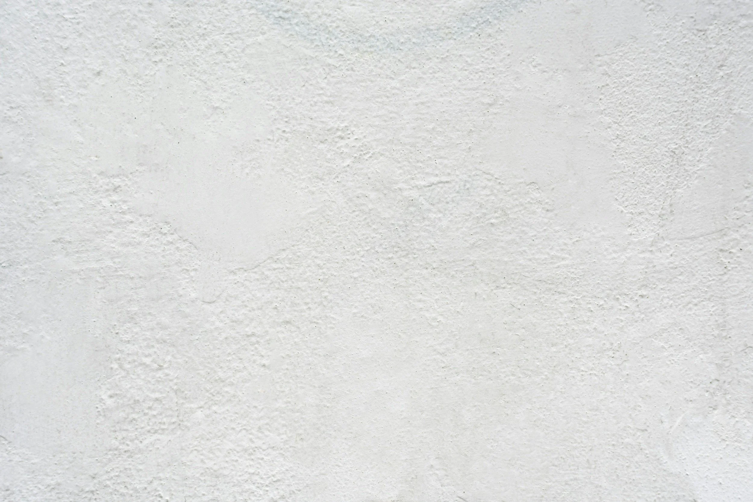 A white textured ceiling or wall surface.