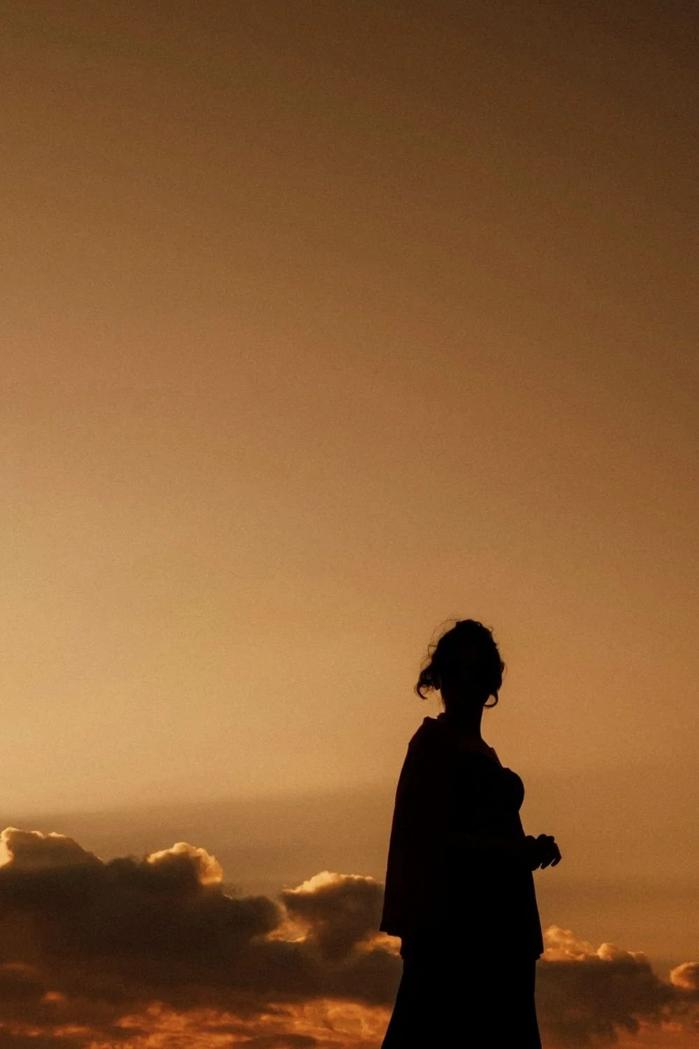 Silhouette of a person standing against a warm sunset sky, conveying reflection, self-discovery, and empowerment inspired by self confidence workshops and personal transformation journeys.