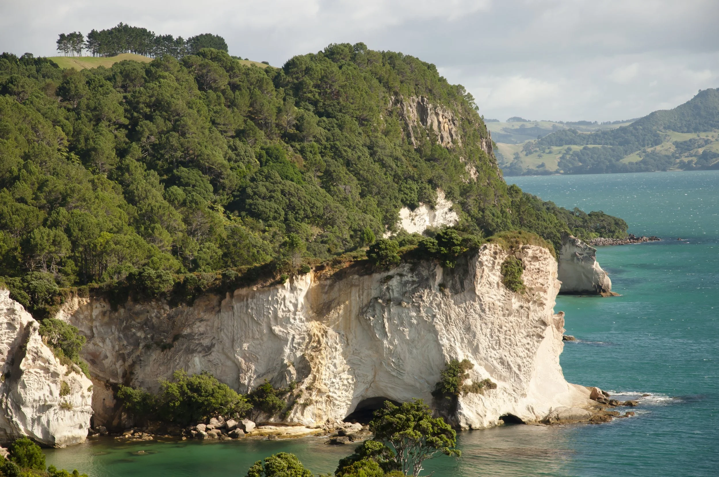 scenic-view-sea-by-mountains-against-sky.jpg