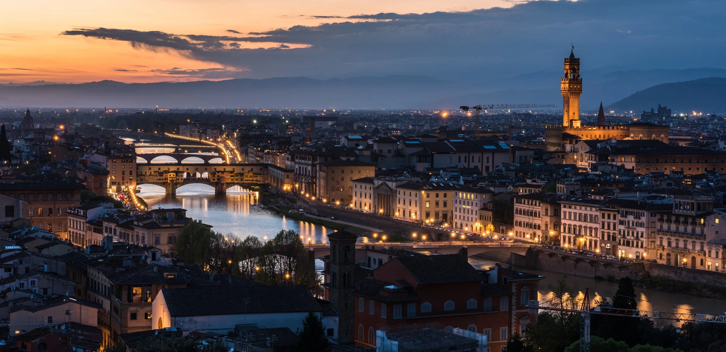 high-angle-shot-lot-buildings-with-lights-bridge-evening.jpg