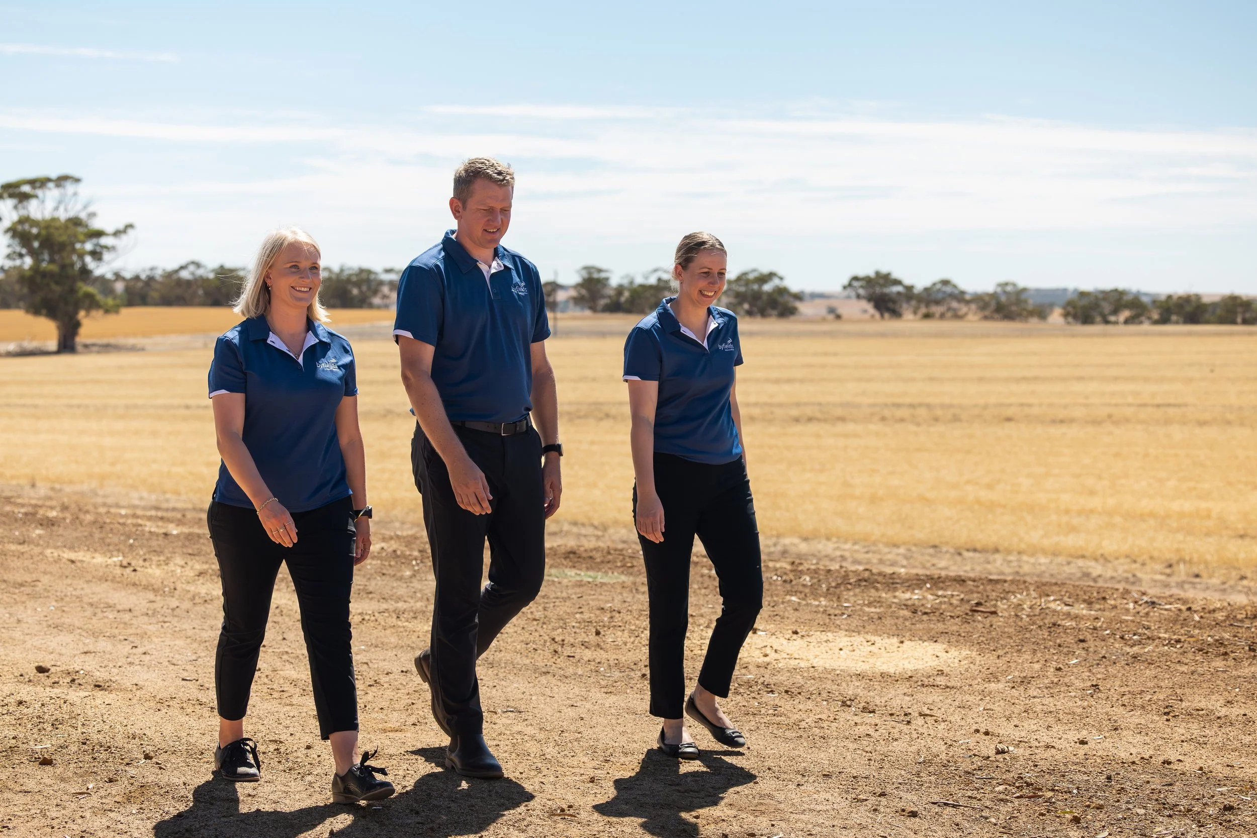 Three Byfields advisers walking through a paddock
