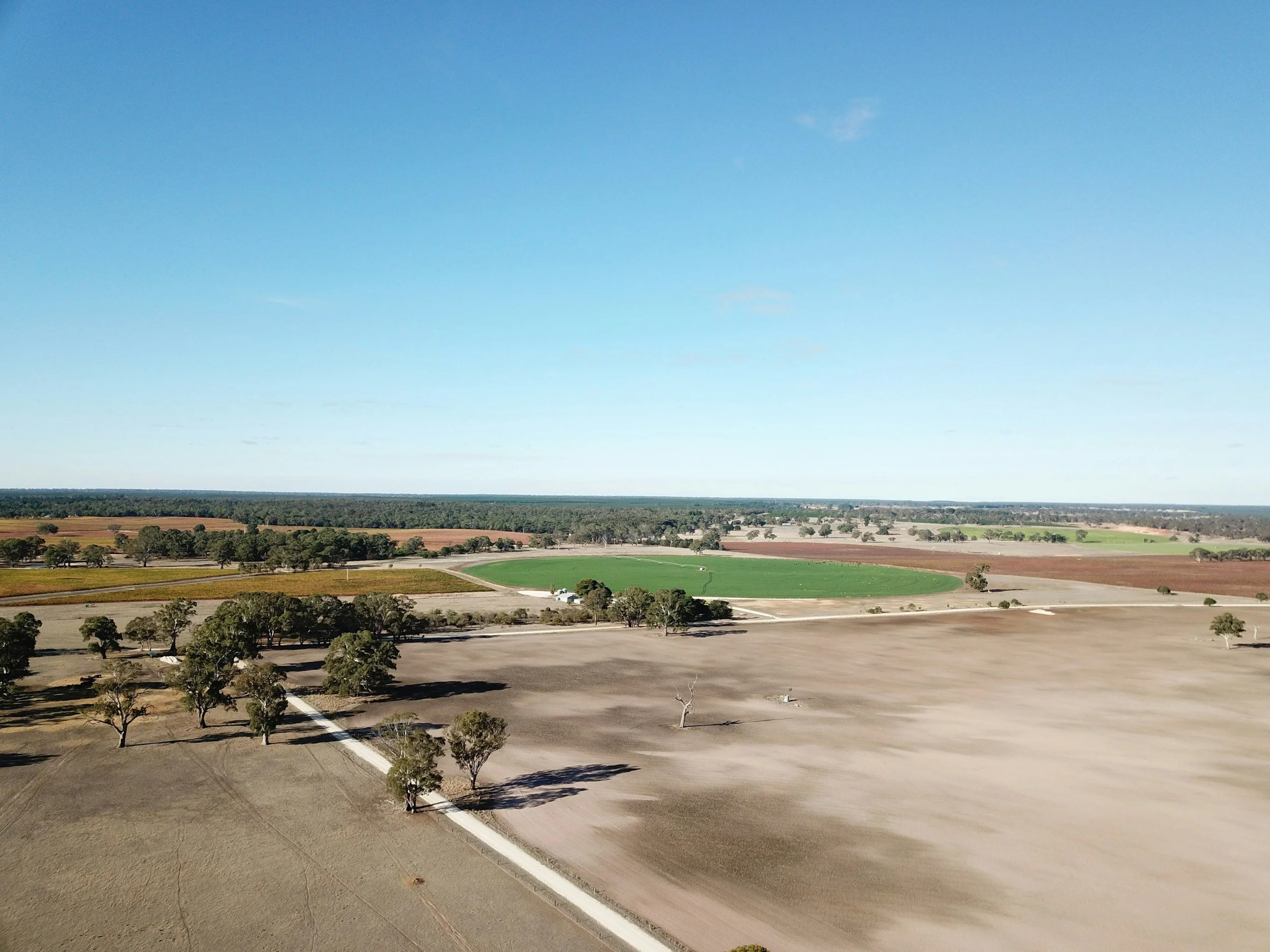 Aerial view of farmland on the edge of a regional town