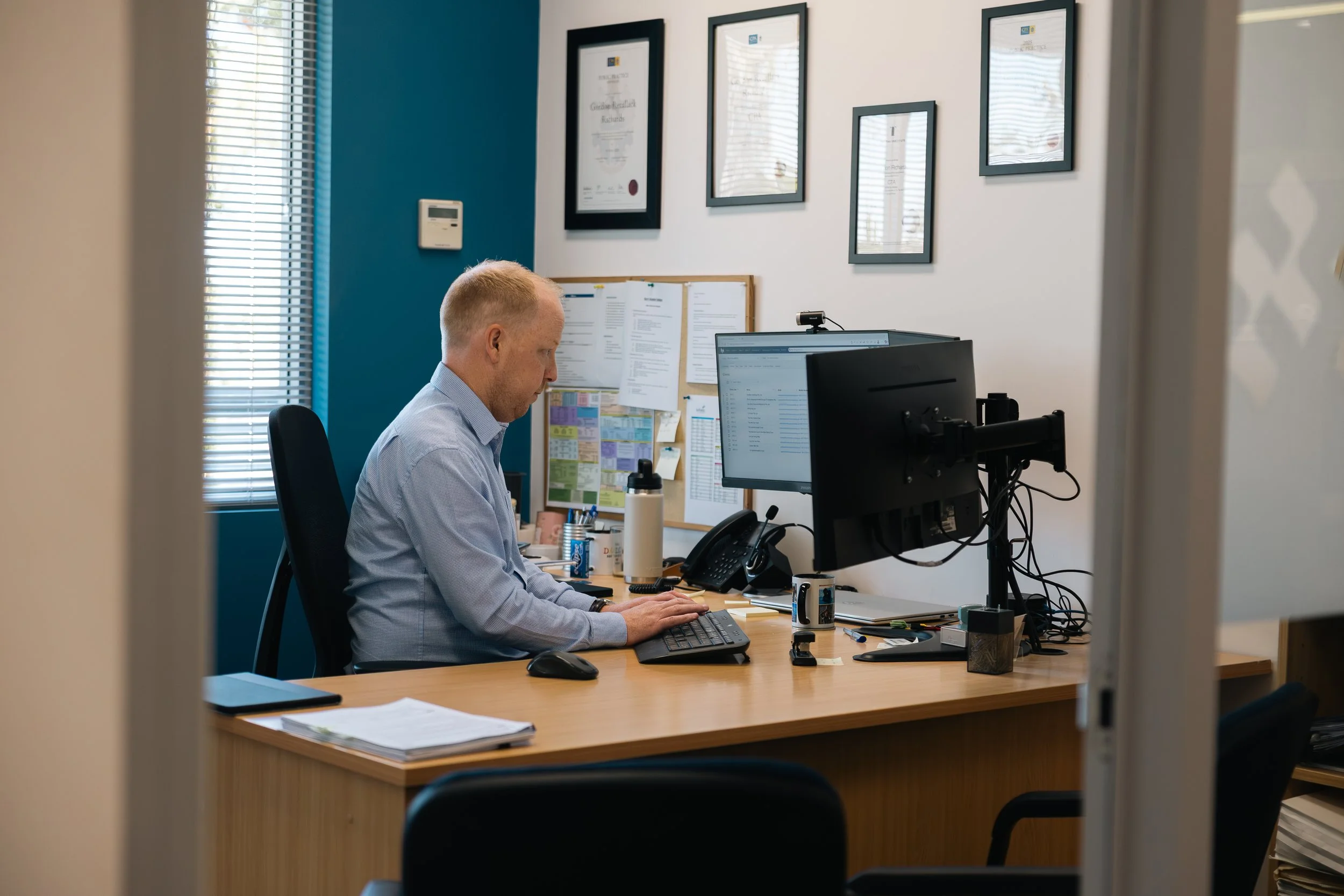 Byfields adviser working at a desk in the office