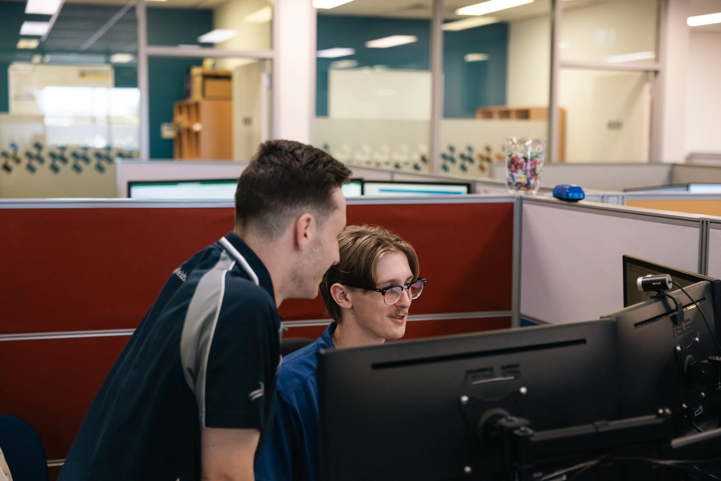 Byfields adviser working with a colleague at a computer