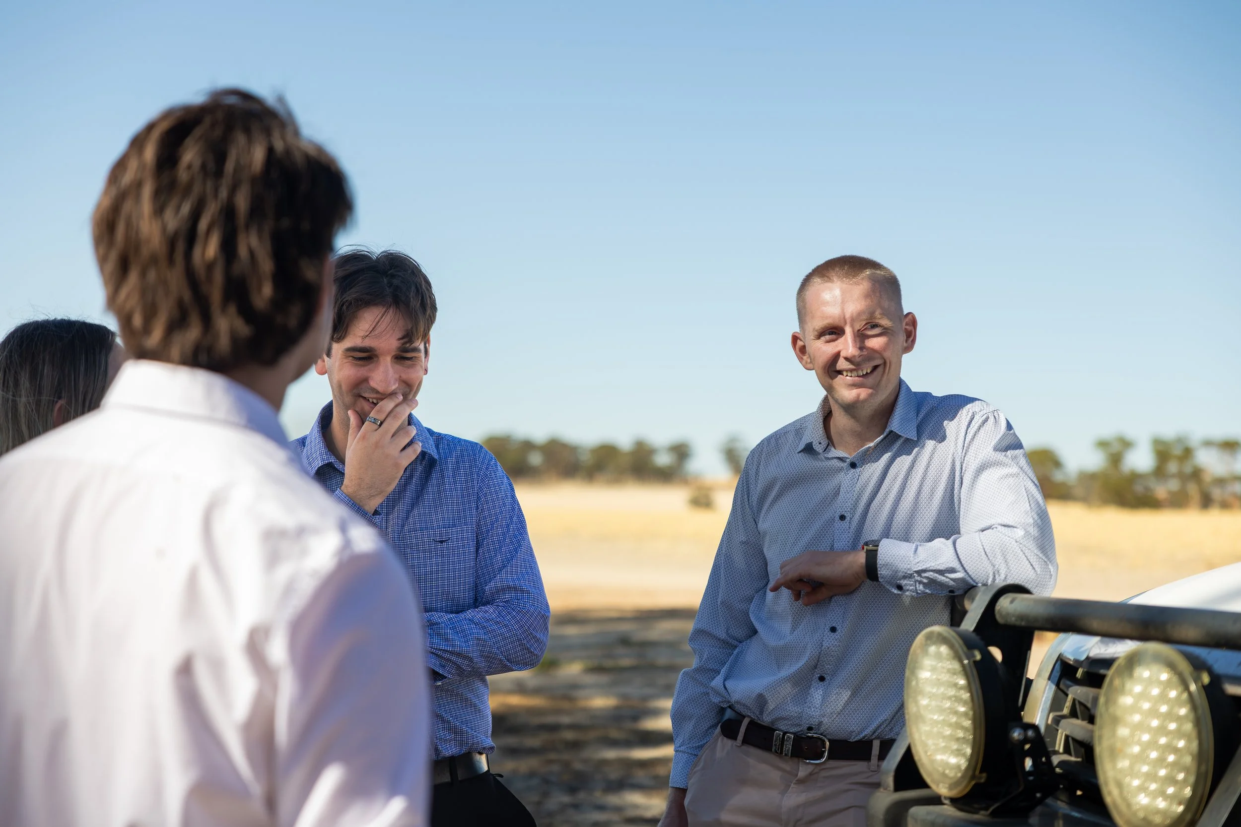 Byfields advisers chatting with a farmer beside a ute
