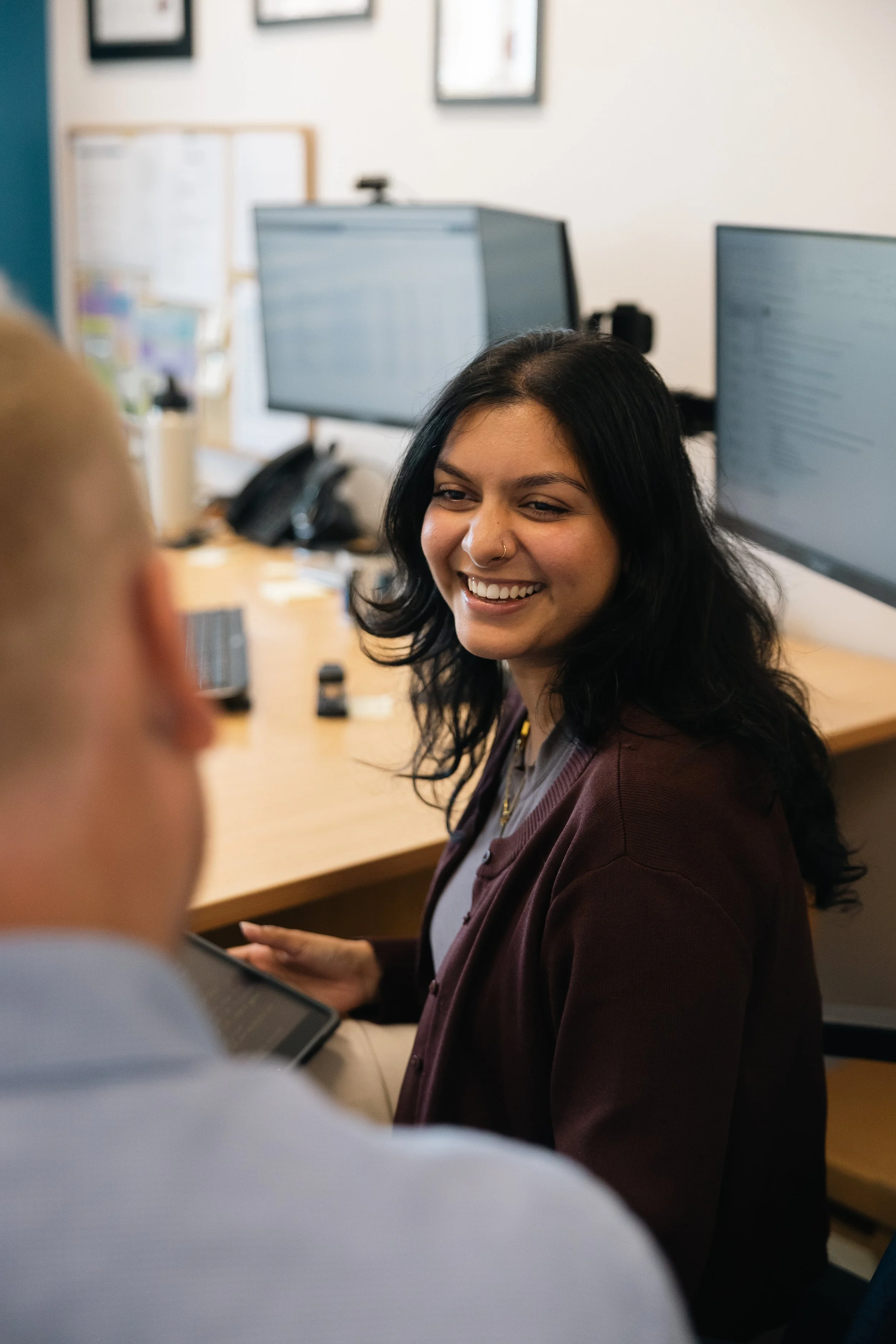 Smiling Byfields team member talking with a colleague in the office