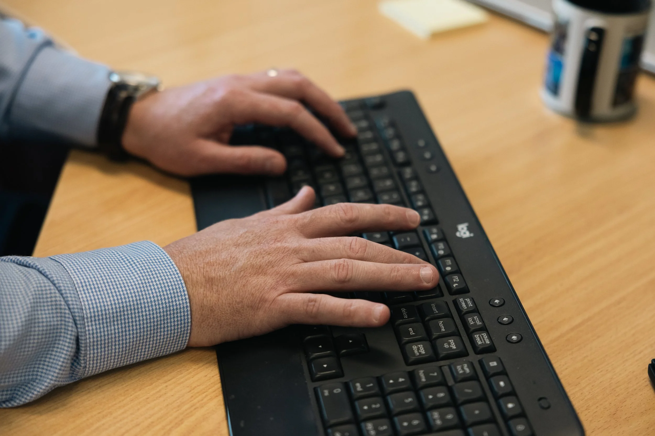 Close-up of hands typing on a keyboard