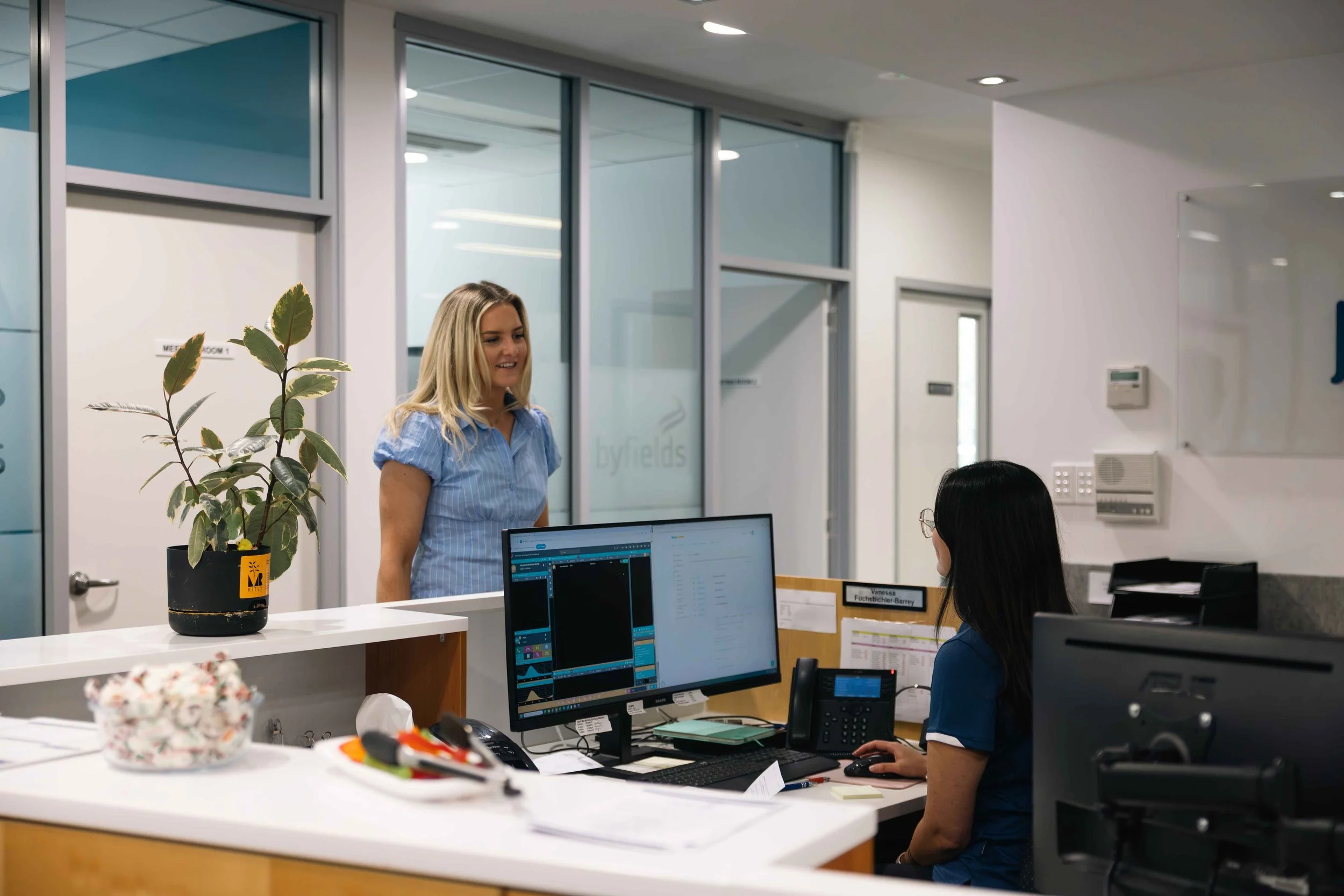 Byfields team members working at desks in a bright open-plan office