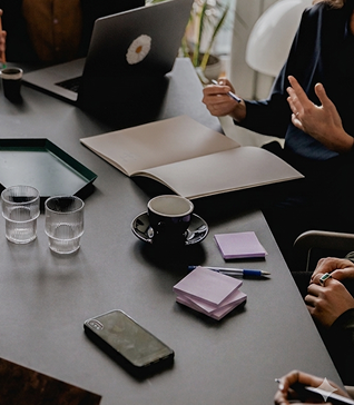 corporate workshop with sticky notes and phone and coffee