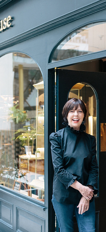 Margaret O'Rourke leaning on a store's door frame