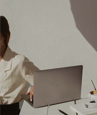 a person working on a laptop in front of an all white background