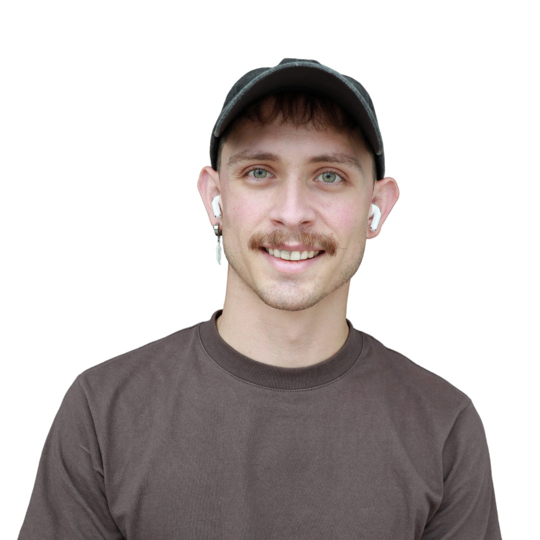 A young man with light skin, wearing a gray cap, brown shirt, and white wireless earbuds, smiling at the camera.