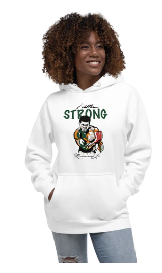 Woman with curly hair wearing a white hoodie with a graphic of a boxer and the text 'I'm Strong'