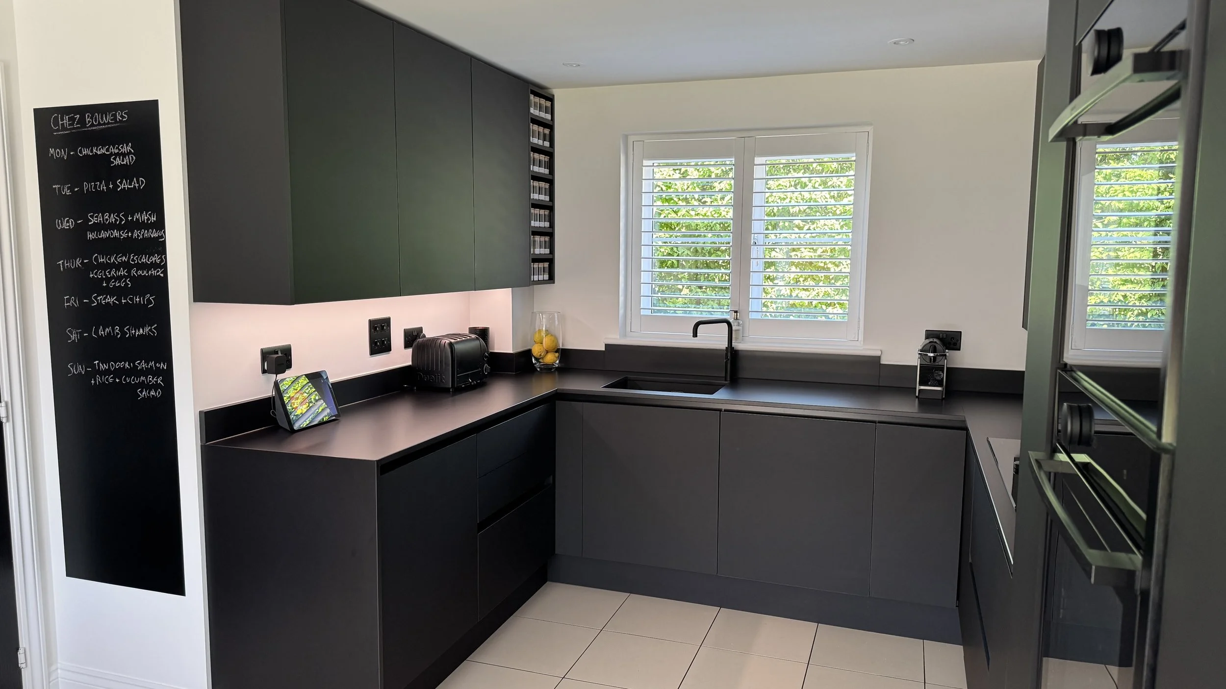 Professionally organised garage storage with shelving, labelled storage bins and practical organisation systems in East Sussex