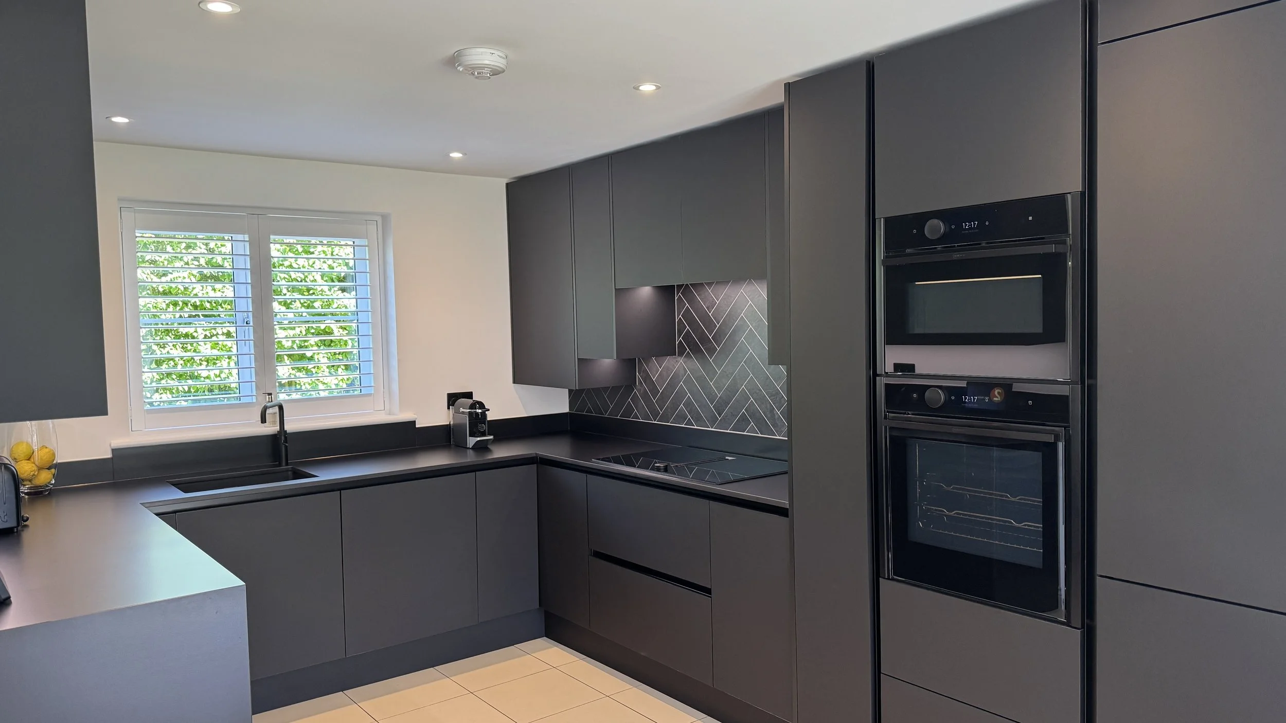 Organised kitchen storage and black cabinetry