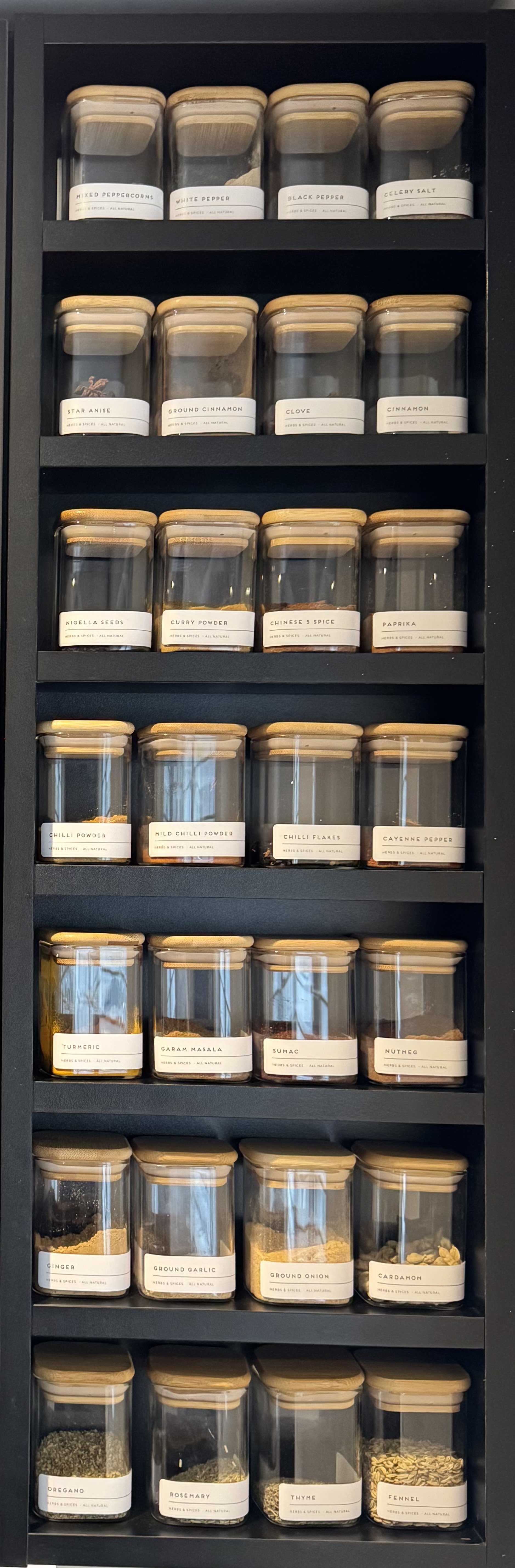 Labelled spice jars in bespoke shelving