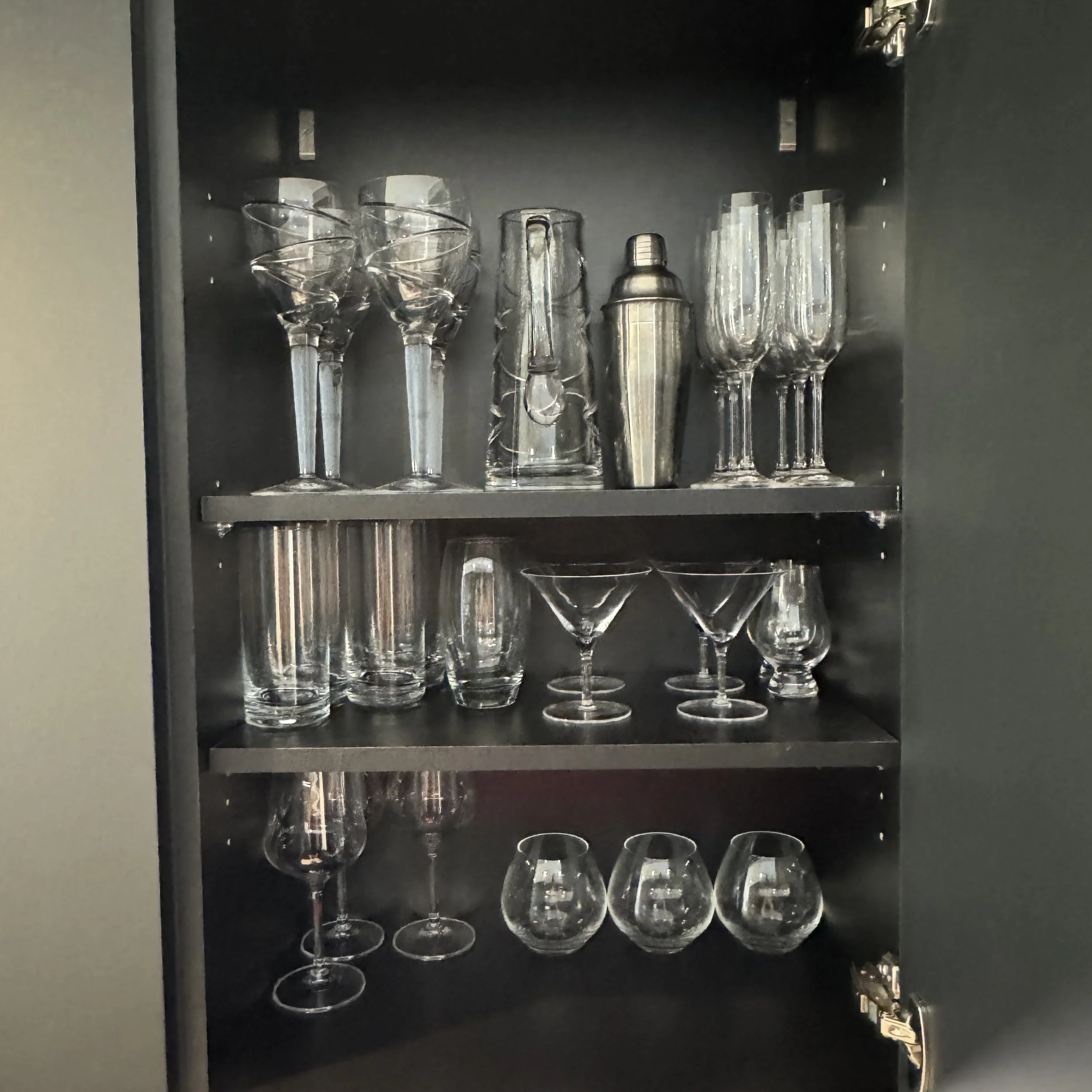 Organised glassware cupboard with cocktail and wine glasses