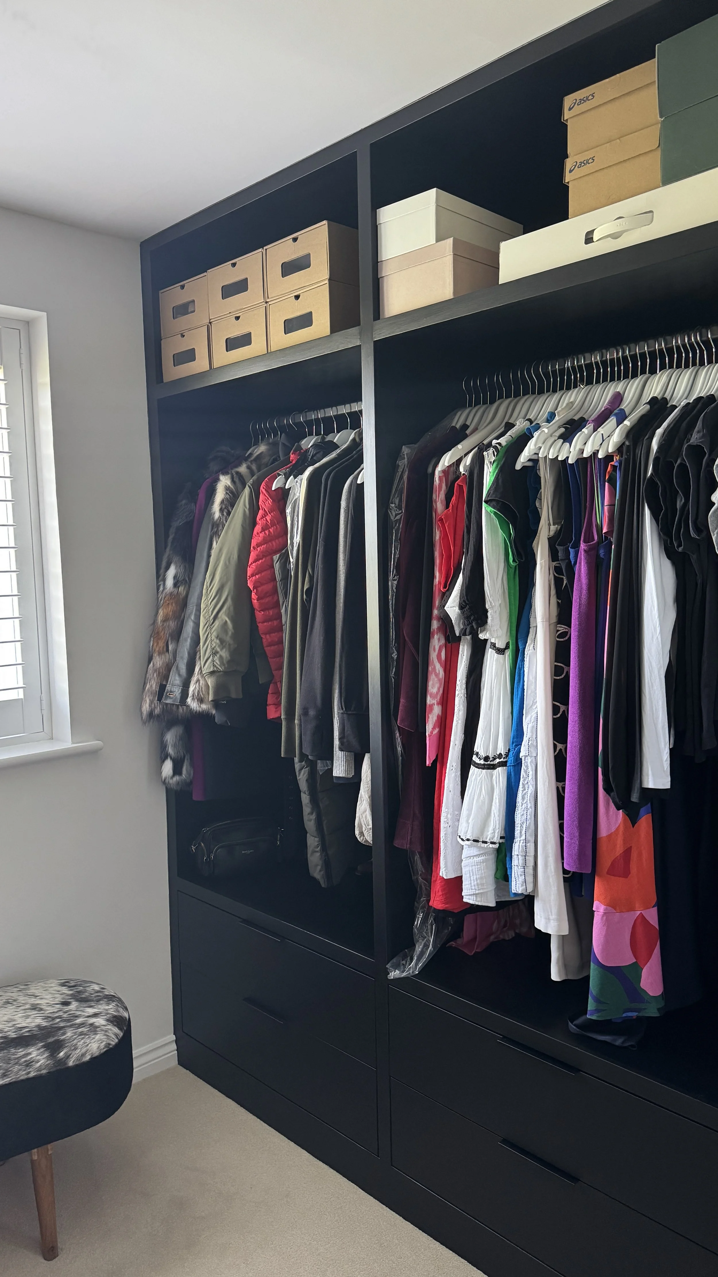 Organised wardrobe with coordinated clothing storage