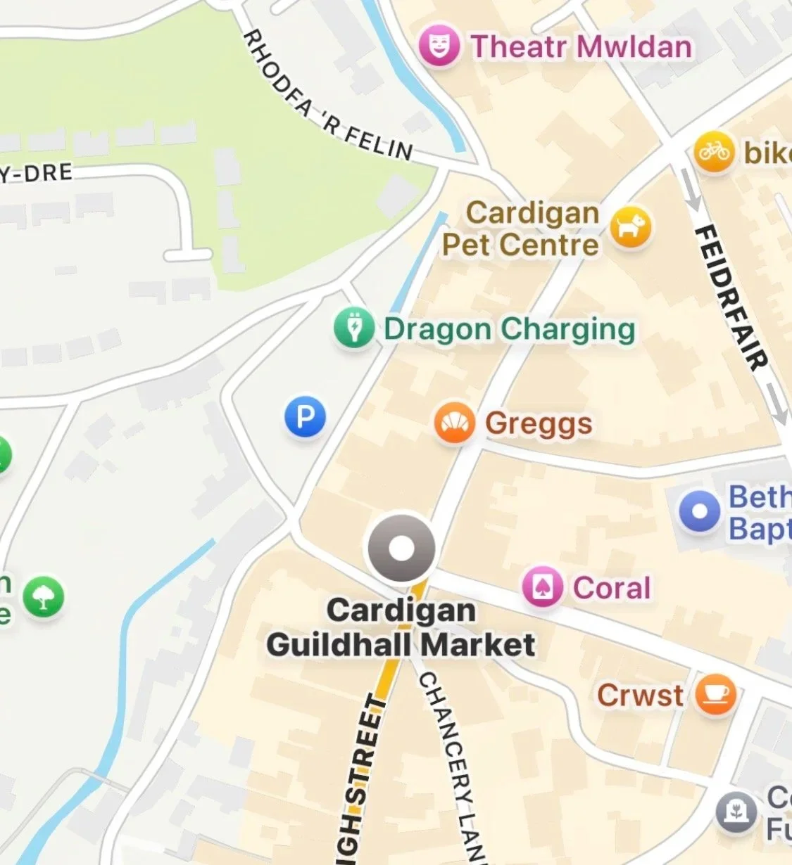 Map showing the area around Cardigan, featuring landmarks such as Cardigan Guildhall Market, Dragon Charging, Greggs, Coral, and a pet center, with streets Milford Road and Feidr Fawr.