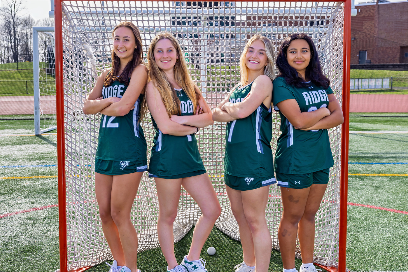 Ridge Girls Lacrosse captains Zoe Colodney, Andrea Dulyn, Charlotte Daniel, and Rylan Broadhurst lead the program with discipline, energy, and teamwork. Their leadership sets the standard for communication, effort, and the “earned, not given” culture