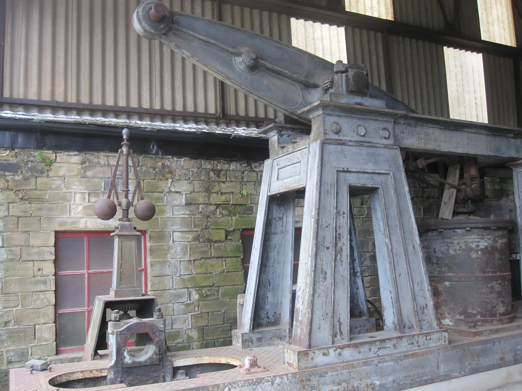 Beams and centrifugal governor of a derelict steam engine at Leeds Industrial Museum, Armley Mills — industrial machinery from the textile industry