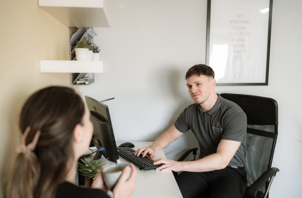 Sports therapist conducting an injury assessment with a client in Swindon.