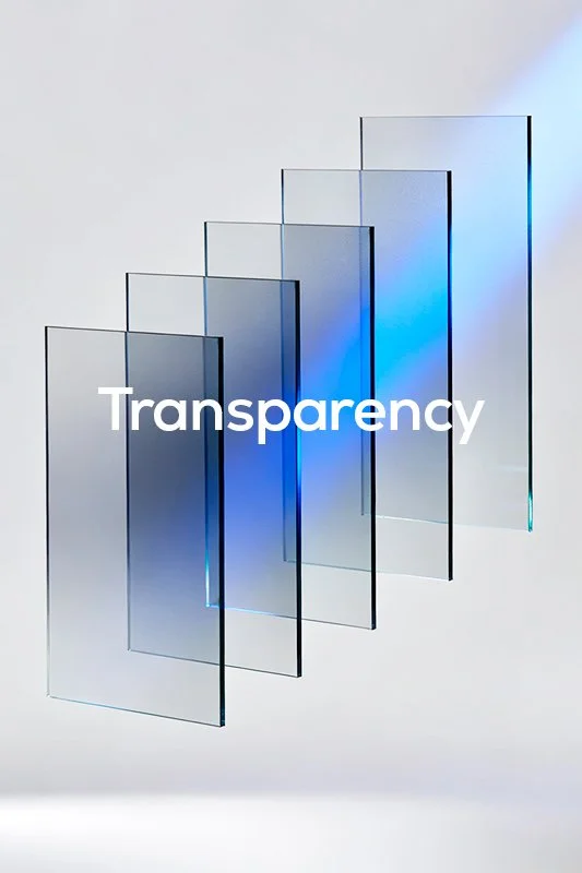 Multiple transparent glass sheets arranged in a staggered formation with the word 'Transparency' overlaid in white letters.