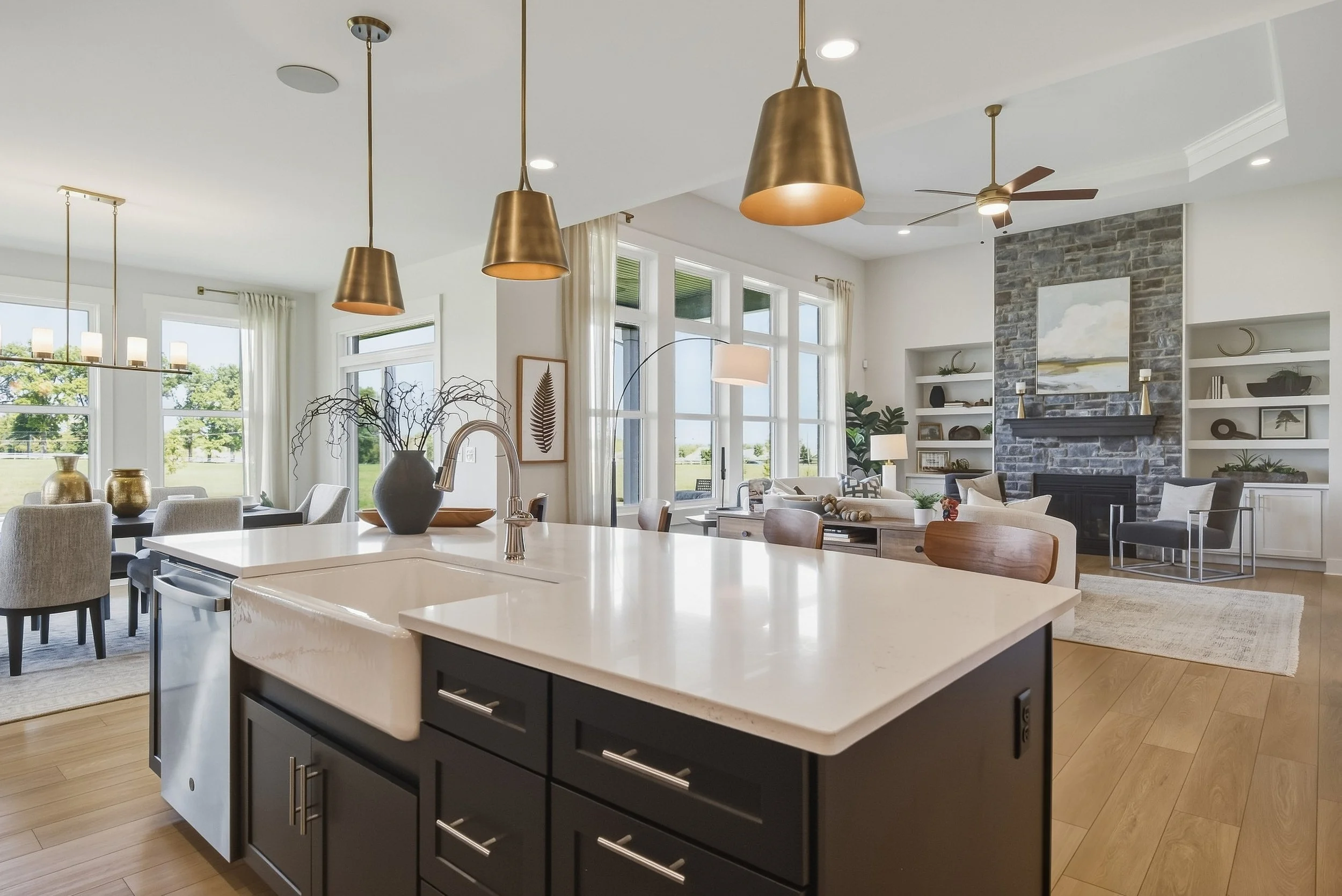Bright open floor plan with kitchen dining and living areas photographed for residential real estate marketing