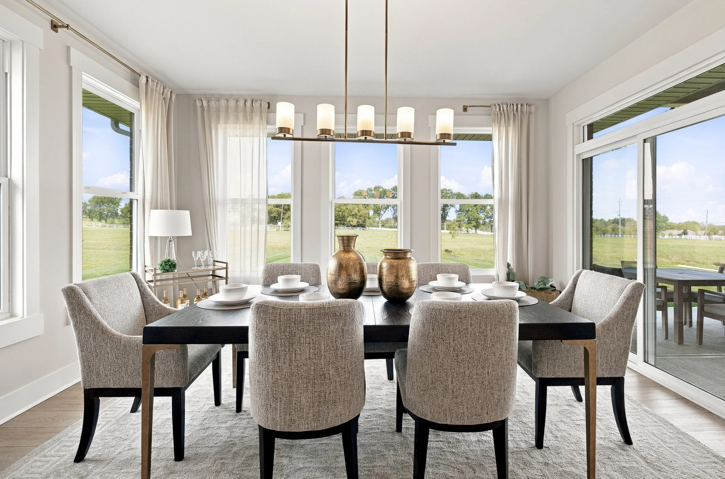 Dining room with large windows and natural light photographed for a residential real estate listing