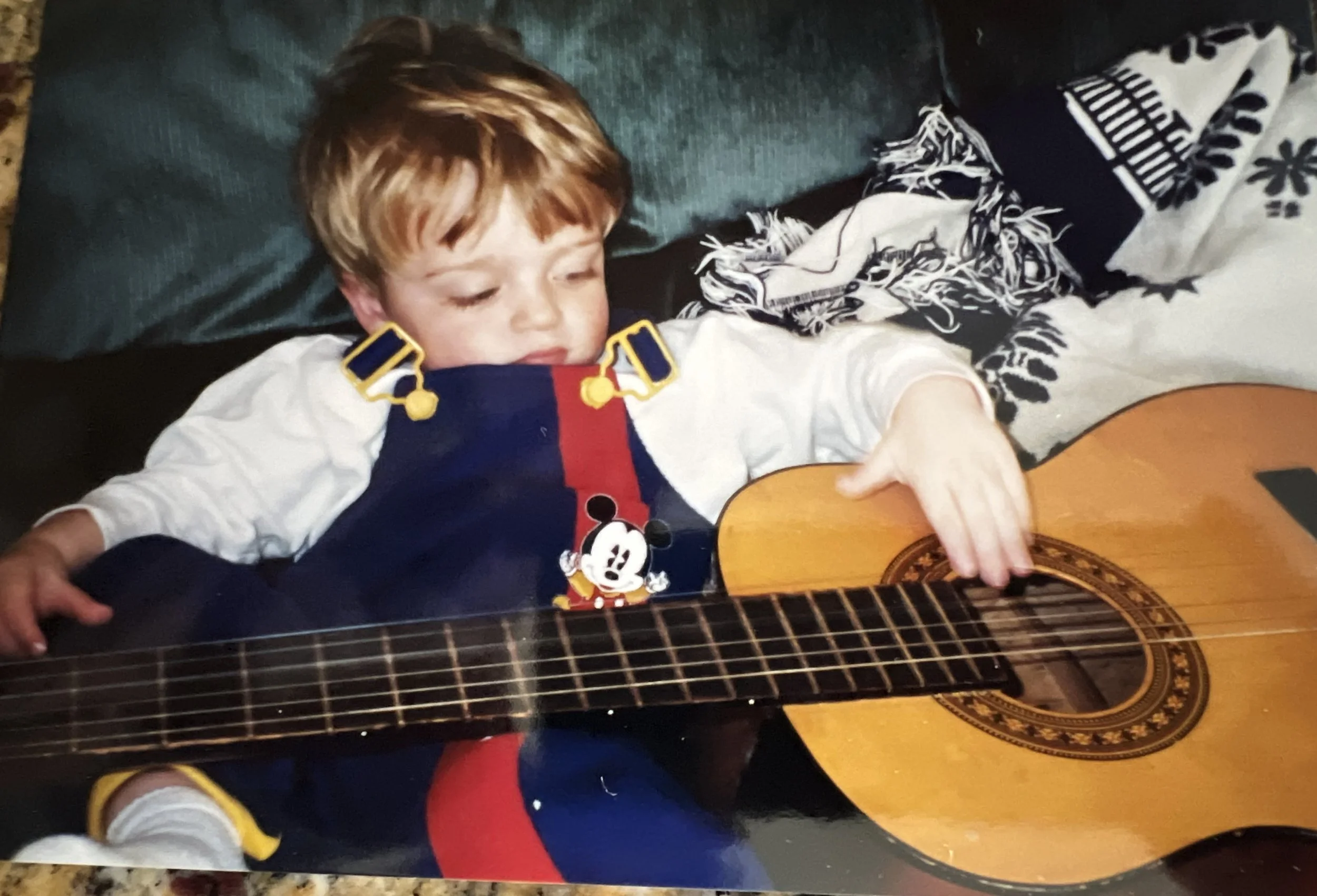 Kyle as a toddler with his first acoustic guitar