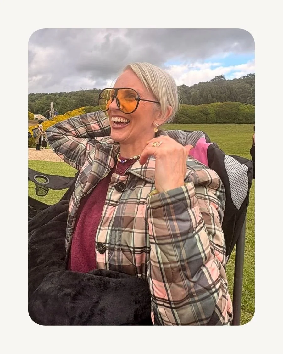 Rhonda, founder of Flossie & Locke, laughing outdoors in a patterned coat.