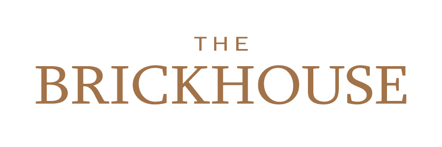 Logo with the text 'The Brickhouse' in bronze letters.