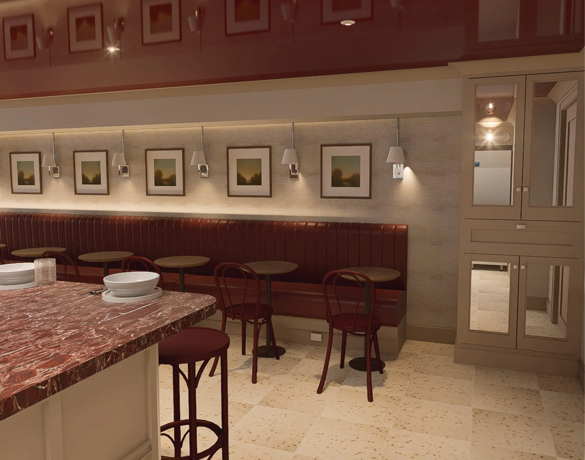 A restaurant dining area with a red marble-topped counter, wooden chairs, framed landscape pictures on the wall, wall-mounted lamps, and a beige and cream color scheme.