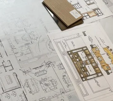 Technical drawings and samples on a table.