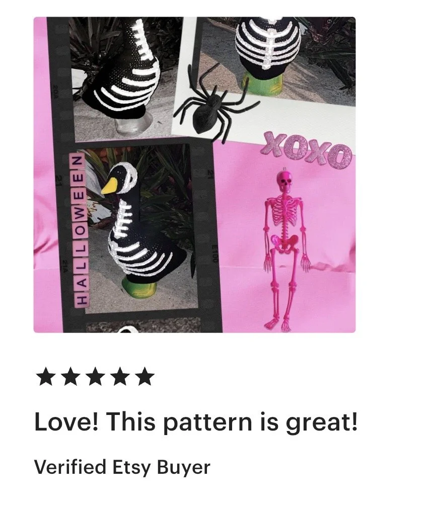Halloween-themed image with a skeleton, a spider, a swan with skeleton pattern, and pink letters spelling 'XOXO' on pink paper.