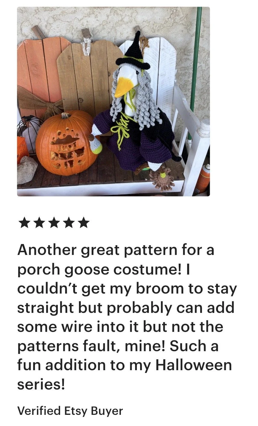 A decorative porch scene featuring a crocheted witch goose costume with a large pumpkin with a carved face, a wooden chair, and Halloween decorations.