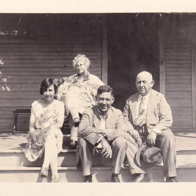 Members of the Harn family seated on a porch
