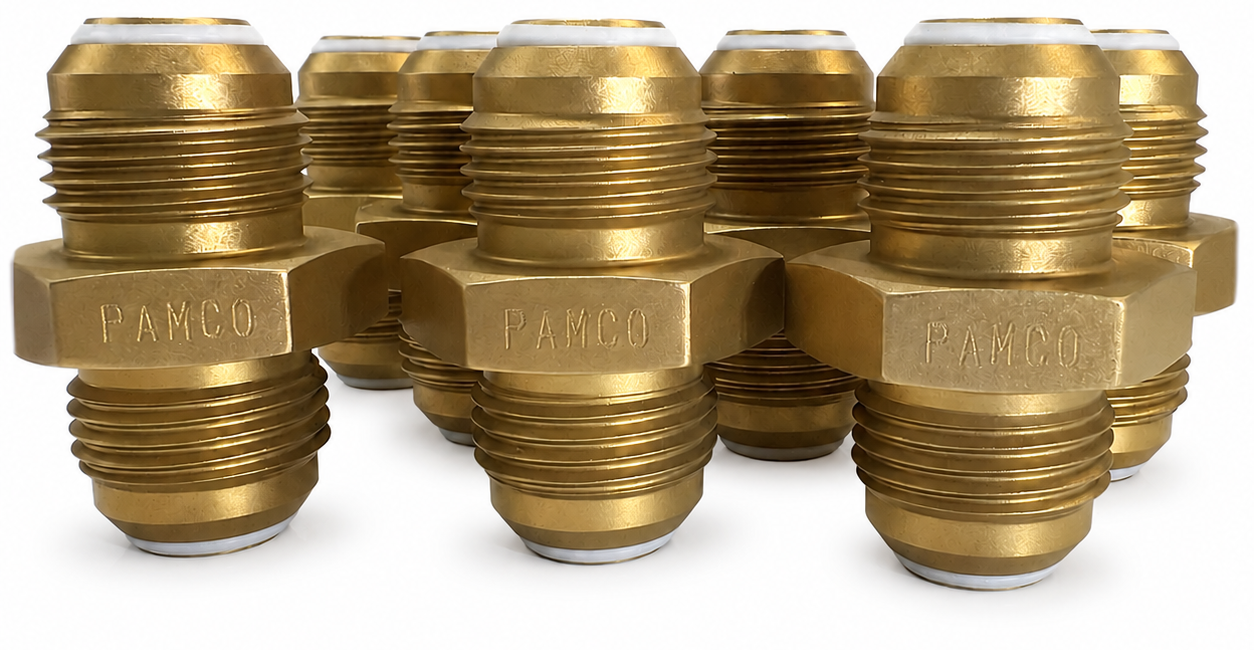 Multiple brass fittings with the brand name 'PAMCO' engraved, arranged in a cluster.
