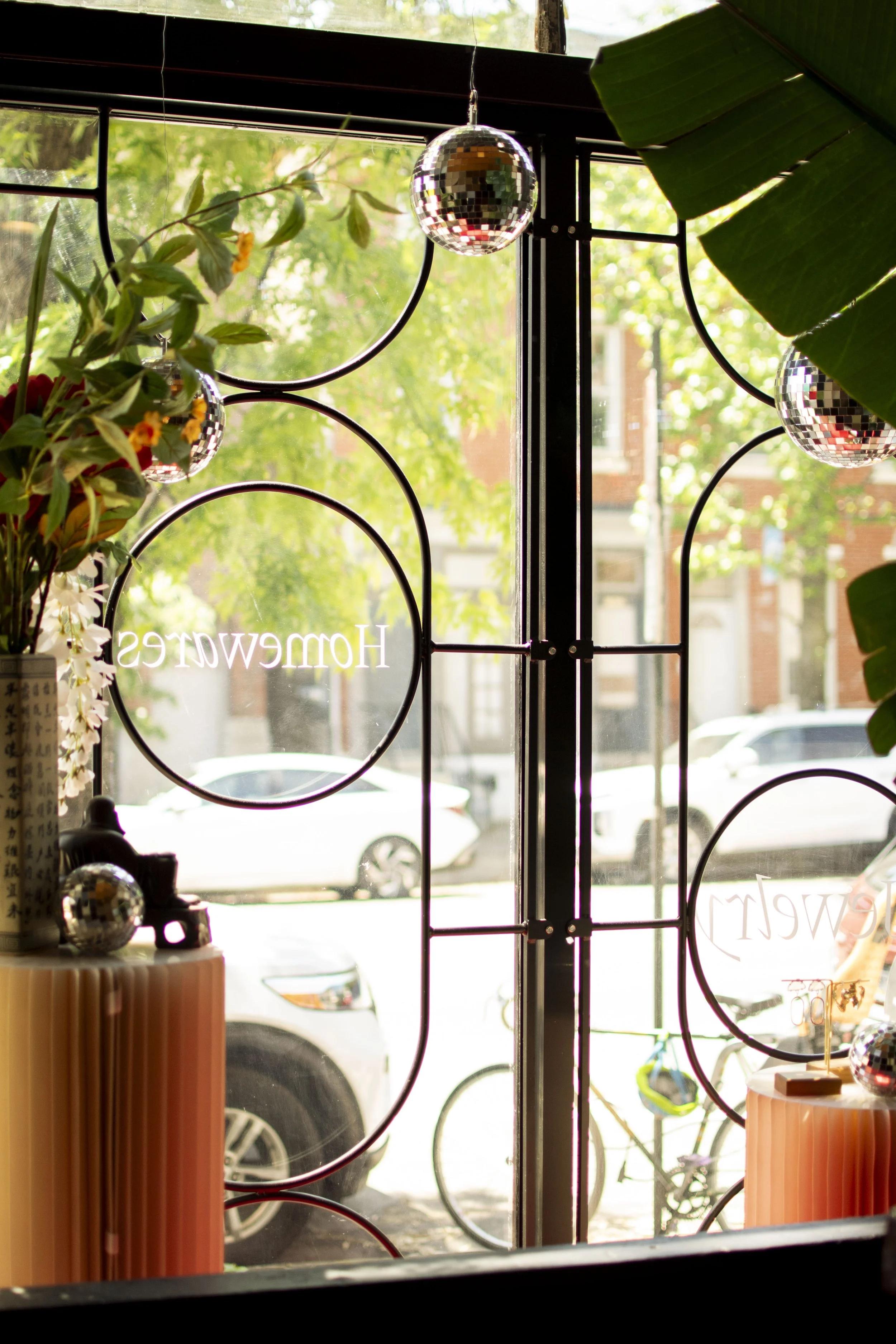 Decorative window bars shown from inside the shop. Round steel bars bent into a pill shape and circles. 