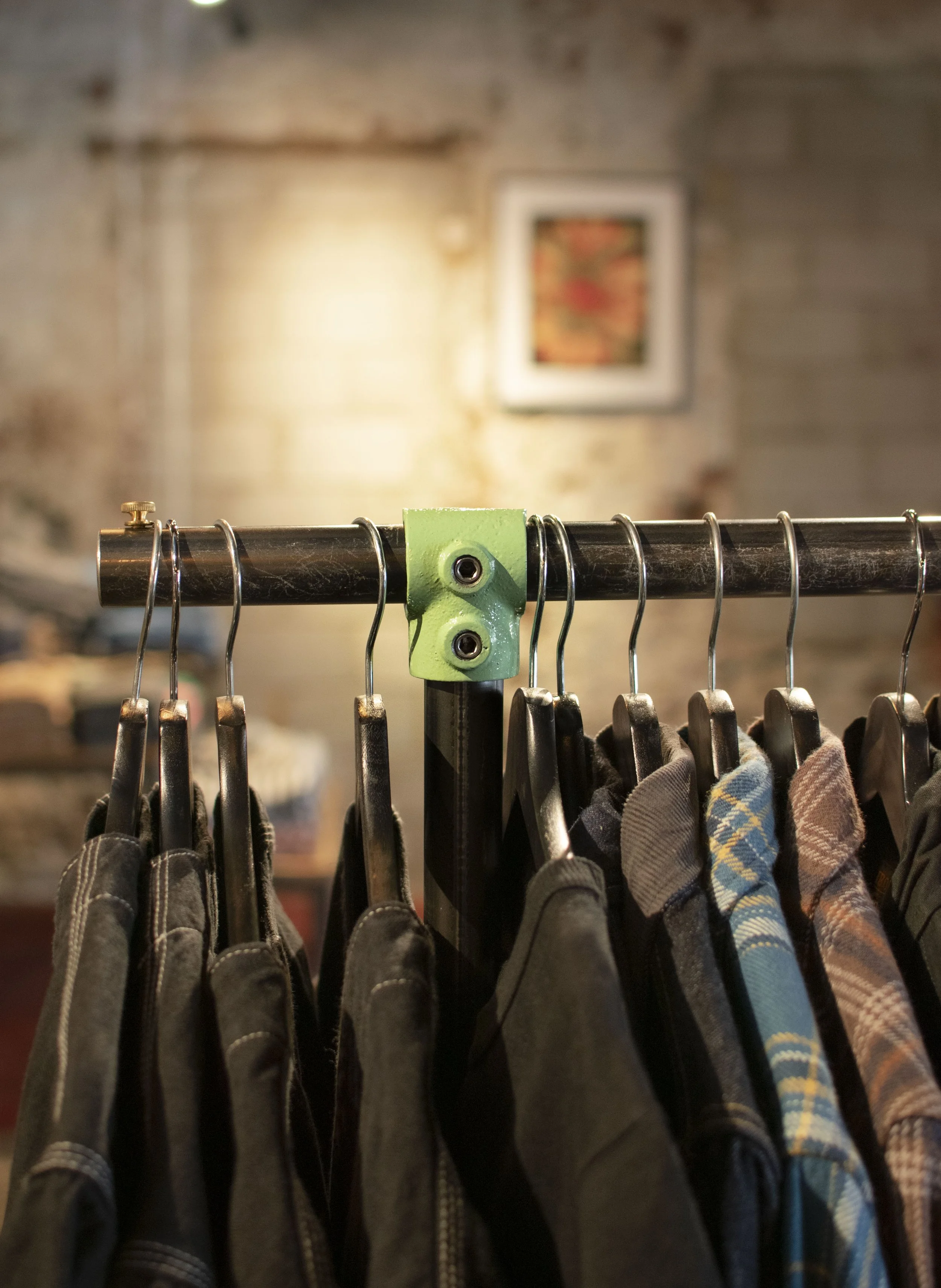 Mint green powder coated pipe attachments for a shirt display