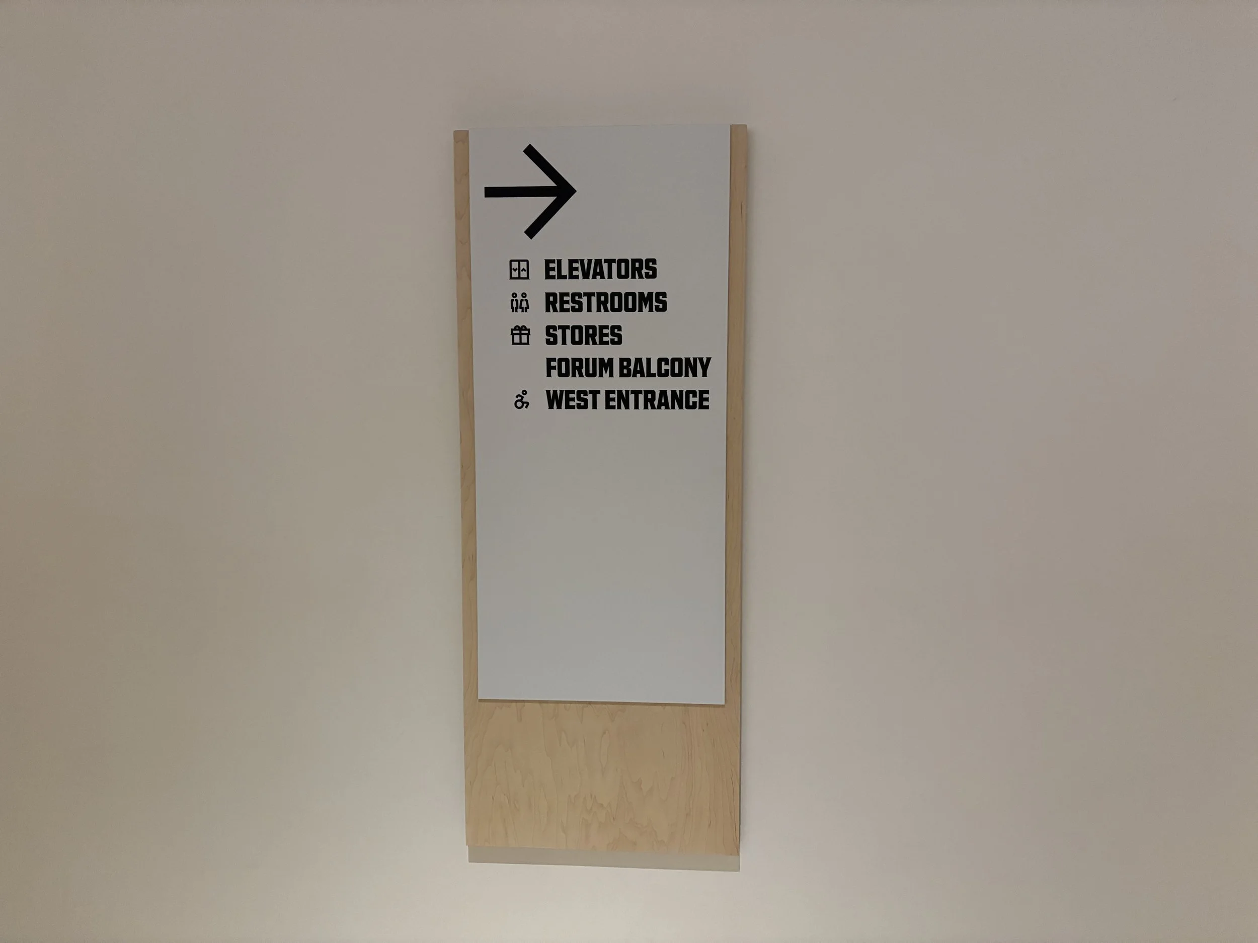 White aluminum and plywood wayfinding signs at the Philadelphia Museum of Art. 